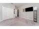 Bedroom with neutral walls and carpet, a large window with blinds, closet and a flat screen TV at 4115 Ruby Run, Haines City, FL 33844