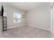 Bedroom with neutral walls and carpet, a window with blinds, closet and a display shelf holding a flat screen TV at 4115 Ruby Run, Haines City, FL 33844