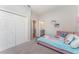 A bright, comfortable ' bedroom features two closets, soft carpet and cute decor at 4115 Ruby Run, Haines City, FL 33844