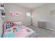 Bedroom featuring a Moana themed bed, a bedside lamp, and a dresser, creating a vibrant and playful space at 4115 Ruby Run, Haines City, FL 33844