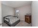 Bedroom featuring a bed with printed patterns, a bedside lamp, and a wooden dresser at 4115 Ruby Run, Haines City, FL 33844