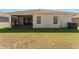 Home exterior showing back patio, lawn, and AC unit at 4115 Ruby Run, Haines City, FL 33844