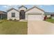 Charming single Gathering home showcasing a well-manicured lawn and a two-car garage at 4115 Ruby Run, Haines City, FL 33844