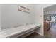 Functional laundry room with a spacious countertop for folding clothes and added convenience with modern sign at 4115 Ruby Run, Haines City, FL 33844