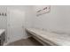 Laundry room with long folding counter, complemented by modern sign and flooring, for a stylish and functional space at 4115 Ruby Run, Haines City, FL 33844