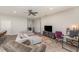 Open concept living room featuring a comfortable sectional sofa, ceiling fan and neutral decor at 4115 Ruby Run, Haines City, FL 33844