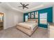 Main bedroom with tray ceiling, ensuite bathroom, and ample natural light from two large windows at 4115 Ruby Run, Haines City, FL 33844