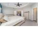 Serene main bedroom with plush carpeting, a ceiling fan, and an ensuite bathroom at 4115 Ruby Run, Haines City, FL 33844