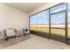 Enclosed patio with seating area overlooking the backyard, perfect for outdoor relaxation at 4115 Ruby Run, Haines City, FL 33844