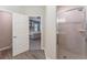 Bathroom featuring a shower with a glass door and tiled walls, with a peek into the bedroom through the doorway at 4115 Ruby Run, Haines City, FL 33844