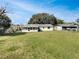 Expansive backyard with a well-maintained lawn, a screened porch, offering ample space for outdoor activities at 437 Georgia Ave, St Cloud, FL 34769