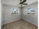 Bedroom featuring two windows with a ceiling fan and natural light at 437 Georgia Ave, St Cloud, FL 34769