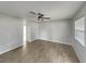 Bright and airy living room with tiled flooring, a ceiling fan, and a view into the adjacent kitchen space at 437 Georgia Ave, St Cloud, FL 34769