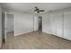 Spacious main bedroom featuring tile flooring, a ceiling fan, and an ensuite bathroom, and closet space at 437 Georgia Ave, St Cloud, FL 34769