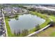 Aerial view of a beautiful community with townhomes surrounding a pond with fountain at 465 Gee Hammock Ln, Winter Springs, FL 32708