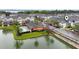 Aerial view of townhouse community featuring a pool, pond and manicured landscaping at 465 Gee Hammock Ln, Winter Springs, FL 32708