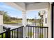 Serene balcony view overlooking a tranquil pond with fountain at 465 Gee Hammock Ln, Winter Springs, FL 32708