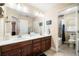 Bright bathroom features double vanity with wood cabinets and a shower-tub combination at 465 Gee Hammock Ln, Winter Springs, FL 32708