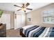 Cozy bedroom with carpet, ceiling fan, closet, and natural light from two windows at 465 Gee Hammock Ln, Winter Springs, FL 32708