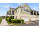 Townhouse with attached garage, balconies, light green paint, and well-maintained lawn at 465 Gee Hammock Ln, Winter Springs, FL 32708