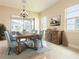 Inviting dining room featuring a wooden table, upholstered chairs, and large windows for natural light at 5266 Buttonsage Dr, St Cloud, FL 34772