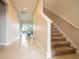 Hallway with stairs and a view of the dining room at 5266 Buttonsage Dr, St Cloud, FL 34772