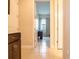 Hallway with access to the laundry room with wooden cabinets at 5266 Buttonsage Dr, St Cloud, FL 34772