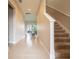 Hallway with stairs and a view of the dining room at 5266 Buttonsage Dr, St Cloud, FL 34772