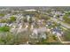 An aerial view showcases a neighborhood with various home styles and mature trees at 5276 Rocking Horse Pl, Oviedo, FL 32765