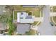 Aerial view of home with solar panels, screened in back patio, manicured lawn, and neighborhood at 5276 Rocking Horse Pl, Oviedo, FL 32765