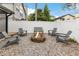 Gravel backyard featuring a brick fire pit surrounded by Adirondack chairs and a bench at 5276 Rocking Horse Pl, Oviedo, FL 32765