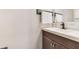 Bathroom vanity featuring a white countertop, bronze faucet, and modern white towel bar at 5276 Rocking Horse Pl, Oviedo, FL 32765