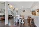 Inviting dining area with wood table, bench seating and seamless flow to the living area with stair access at 5276 Rocking Horse Pl, Oviedo, FL 32765