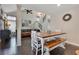 Inviting dining area featuring a wood table, seating bench, staircase access, and seamless flow to living area at 5276 Rocking Horse Pl, Oviedo, FL 32765