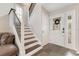 Inviting foyer featuring a staircase with metal railings and dark wood steps, with slate flooring at 5276 Rocking Horse Pl, Oviedo, FL 32765