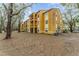 Exterior shot of building with multiple balconies and mature trees at 5291 Images Cir # 302, Kissimmee, FL 34746