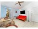 The living room with white tile floor, a ceiling fan, and a sliding glass doors leading to a porch at 5291 Images Cir # 302, Kissimmee, FL 34746