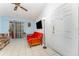 The living room with white tile floor, a ceiling fan, and a sliding glass doors leading to a porch at 5291 Images Cir # 302, Kissimmee, FL 34746