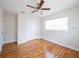 Cozy bedroom featuring hardwood floors, a ceiling fan, and a closet at 5513 Riordan Way, Orlando, FL 32808