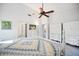 Spacious bedroom boasting a neutral color palette, ceiling fan, and ample closet space at 7213 Greenville Ct, Orlando, FL 32819