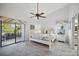 Bright bedroom featuring a four-poster bed, ceiling fan, and sliding glass door to the outside patio at 7213 Greenville Ct, Orlando, FL 32819