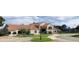 Community clubhouse featuring an attractive terracotta roof, a parking area, and well manicured landscaping at 7213 Greenville Ct, Orlando, FL 32819