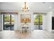 Cozy breakfast nook features a charming chandelier and sliding doors opening to a green, private yard at 7213 Greenville Ct, Orlando, FL 32819