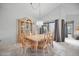 Traditional dining room with light wood furniture, statement chandelier, and sliding glass doors for natural light at 7213 Greenville Ct, Orlando, FL 32819