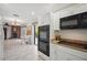 Bright kitchen with white cabinets, granite countertops, and modern appliances with a view to the living space at 7213 Greenville Ct, Orlando, FL 32819