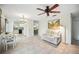 Bright living area with tile flooring, ceiling fan, and a cozy seating area adjacent to the kitchen at 7213 Greenville Ct, Orlando, FL 32819