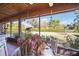 Charming screened porch with a glass table and a tranquil view of the lush backyard at 7213 Greenville Ct, Orlando, FL 32819