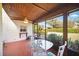 Screened porch with a ceiling fan offers an inviting outdoor living space to entertain at 7213 Greenville Ct, Orlando, FL 32819