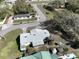 Aerial view of the home showing its backyard, the street, nearby homes and mature trees at 820 Dove Ridge Dr, Lakeland, FL 33803