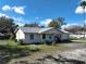 This single-Gathering home features a well-kept front yard, a covered front porch, and a white exterior at 820 Dove Ridge Dr, Lakeland, FL 33803